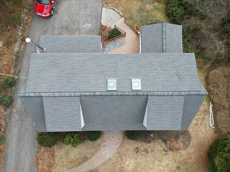 Gray shingle roof with two skylights