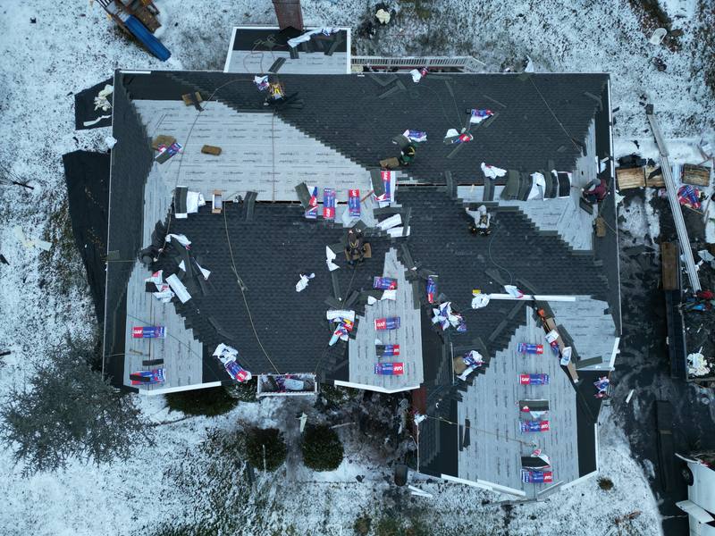 Winter roof replacement in progress, top-down aerial