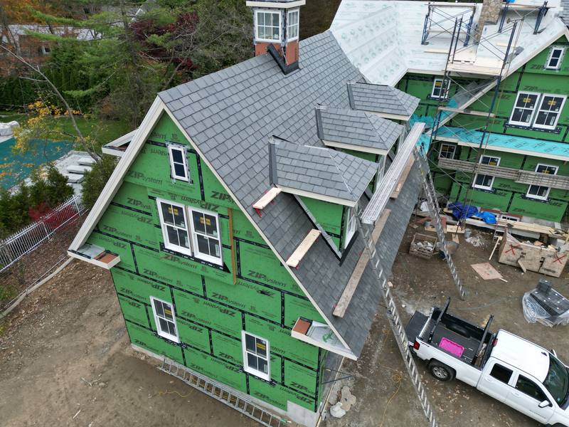 New windows and white trim on a wrapped new-construction wall
